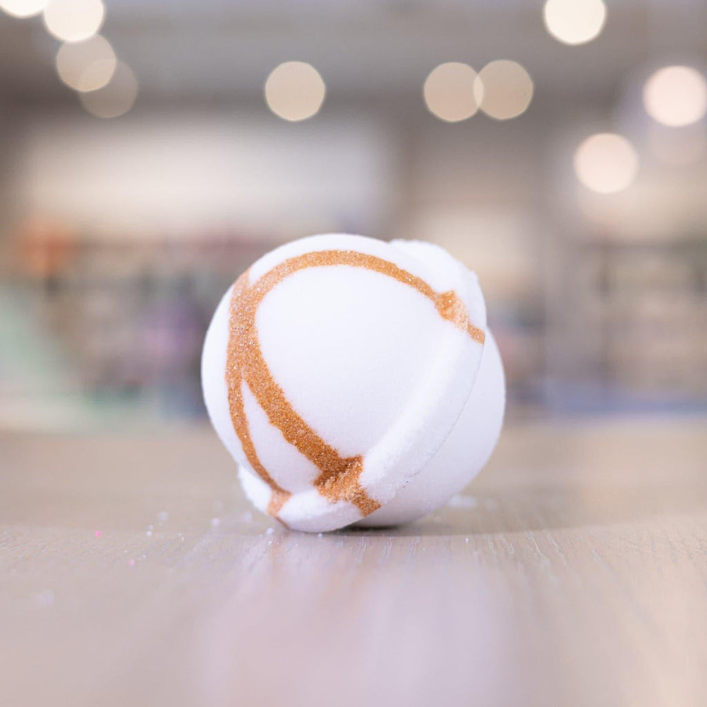 White Narcissist Bath Bomb with bronze spiral design